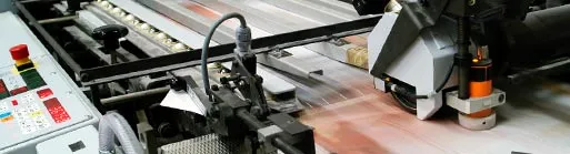 An offset press running a sheet